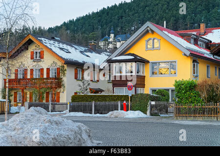 View of the typical alpine houses in a small Bavarian town Garmisch-Partenkirchen in winter. It is a mountain resort town in Bavaria, southern Germany, in the heart of the Alps Stock Photo