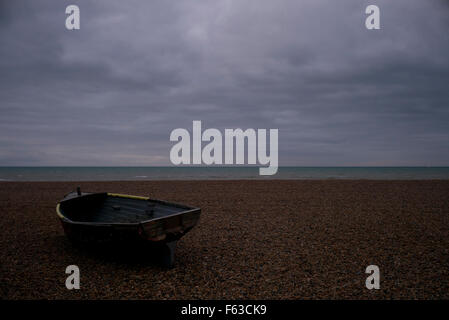 Old wooden boat on beach before sunrise, Brighton, UK Stock Photo