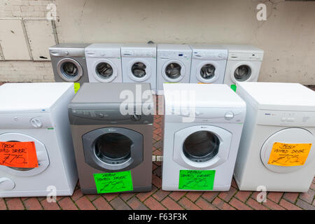 Second hand white goods. Old and previously used washing machine and tumble dryer sale on a UK town centre street. Nottinghamshire, England, UK Stock Photo