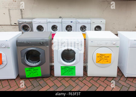 Old washing machines and second hand tumble dryers for sale on a UK town centre street Stock Photo