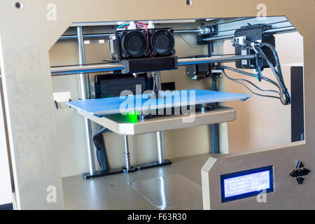 Electronic three dimensional (3D) plastic printer in a laboratory making the Eiffel Tower. Stock Photo