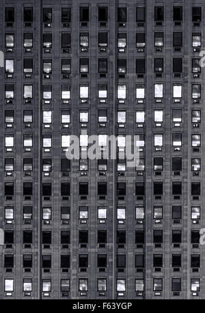exterior blue light on windows on a hight office building Stock Photo