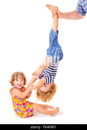 Happy little sister and brother playing together on white background Stock Photo