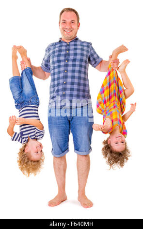 Happy father holding his smiling children upside down isolated on white background. Stock Photo