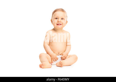 Studio shot of an adorable little baby girl in white diapers smiling and looking up isolated on white background Stock Photo