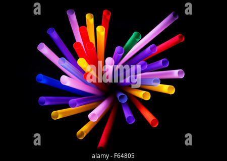 Drinking straws of all colors on black background. Stock Photo
