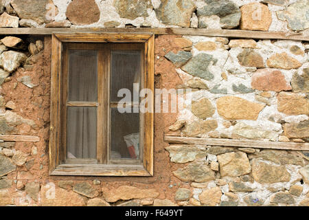 old window in an ancient brick wall in an abandoned farm barn, Stock Photo