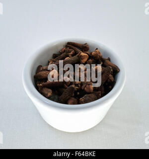 A pot of cloves, the aromatic flower buds of a tree in the family Myrtaceae, Syzygium aromaticum Stock Photo