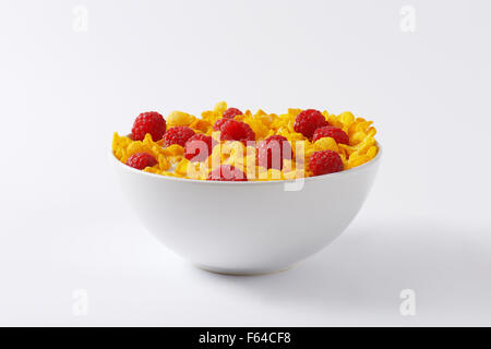 healthy breakfast - bowl of cornflakes and raspberries in milk Stock Photo