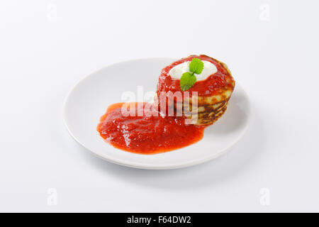 stack of hot pancakes with strawberry jam on white plate Stock Photo