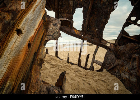 Inside a  shipwreck rotting on a sandy beach Stock Photo