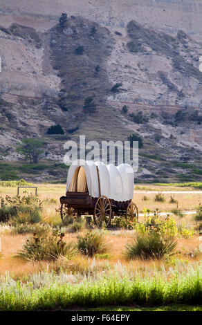 A covered wagon replica stands near the entrance to Scotts Bluff National Monument in western Nebraska. Stock Photo