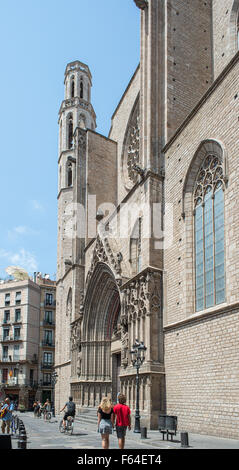 Cyclists and walkers in front of the principal facade of the Basilica de Santa Maria del Mar. Located in Barcelona, Spain Stock Photo