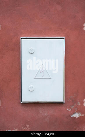 hight voltage electric board on red wall Stock Photo