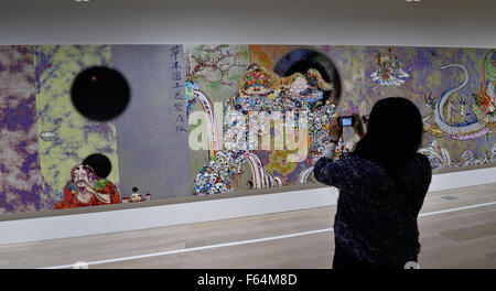 Tokyo, Japan. 11th Nov, 2015. Art patrons photograph the captivating art work of Japan's internationally acclaimed contemporary artist Takashi Murakami at the exhibition entitled Takashi Murakami: The 500 Arhats at the Mori Art Museum, Tokyo, Japan. Photography in the galleries of the exhibition Takashi Murakami: The 500 Arhats is permitted for private use and for sharing on social media websites. The exhibition at the Mori Art Museum runs from October 31, 2105 through March 6, 2016. © 2015 Takashi Murakami/Kaikai Kiki Co., Ltd. All Rights Reserved. © Rory Merry/ZUMA Wire/Alamy Live News Stock Photo
