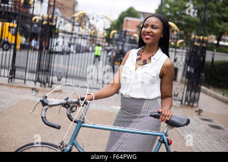 young woman with a bicycle Stock Photo
