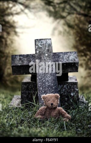 a grave with a teddy bear Stock Photo