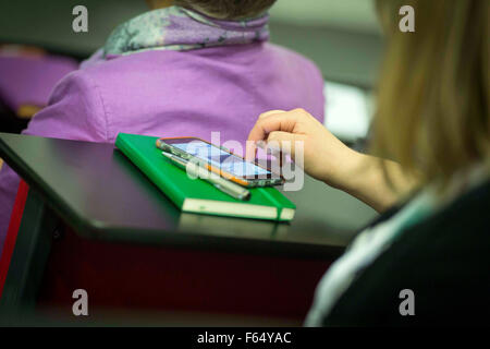 a woman uses a a touch screen smartphone Stock Photo