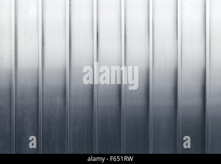 Shining metal wall with stiffening structure lines relief, background photo texture Stock Photo