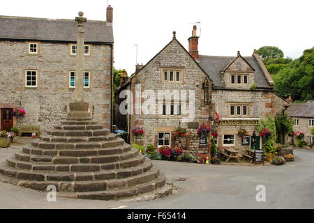 The market cross outside the King's Head public house in the centre of Bonsall village in the Derbyshire Dales England UK,summer Stock Photo