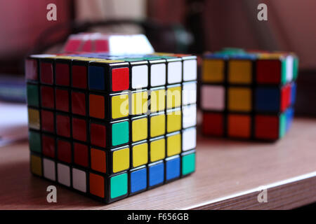 Scrambled puzzle cubes on a wooden desk Stock Photo