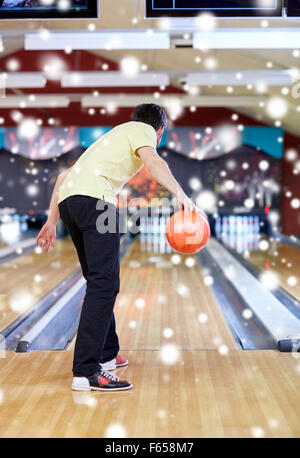 young man throwing ball in bowling club Stock Photo