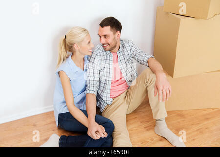 couple with cardboard boxes moving to new home Stock Photo