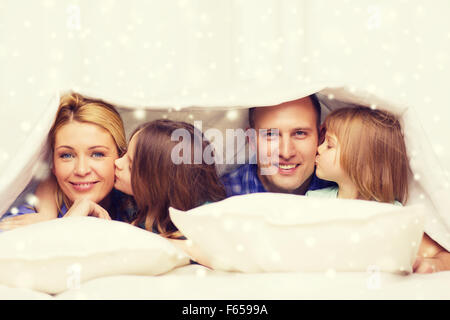 happy family with two kids under blanket at home Stock Photo