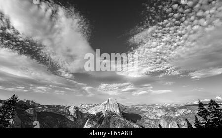 Black and white photo of cloudscape over Half Dome in Yosemite National Park, USA. Stock Photo