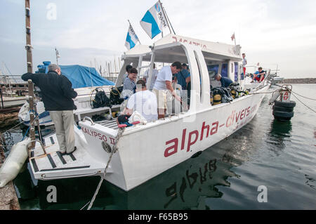 A SCUBA diving club in Larnaca, Cyprus. Divers are readying their equipment on the dive boat before leaving for sea Stock Photo