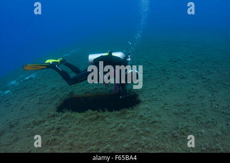 Diver at the MS Zenobia shipwreck. MS Zenobia was a Swedish built Challenger-class RO-RO ferry launched in 1979 that capsized an Stock Photo