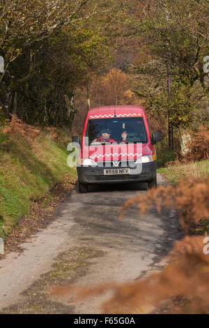 Royal Mail, Post Brenhinol, van driving along rural lane in Doethie Valley, at its confluence with the Upper River Tywi in Mid Wales, UK in November Stock Photo