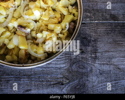 Nov. 3, 2015 - Potatoes fried in lard, in the frying pan made of stainless steel on weawering wooden table © Igor Goiovniov/ZUMA Wire/Alamy Live News Stock Photo