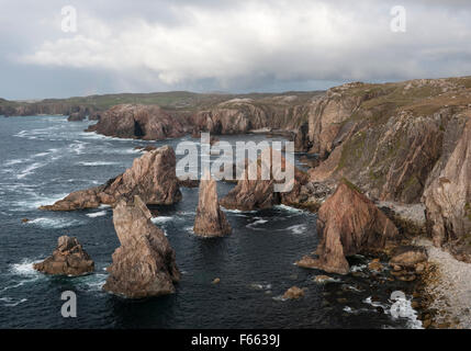 Geodh 'an Fhithich: a group of sea stacks formed by erosion of cliffs SW of Mangersta beach & Rubh 'an Taroin headland (rear L), Isle of Lewis. Stock Photo