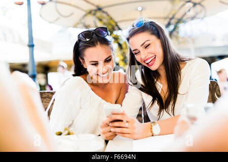 Two young girls talking and smiling during lunch break