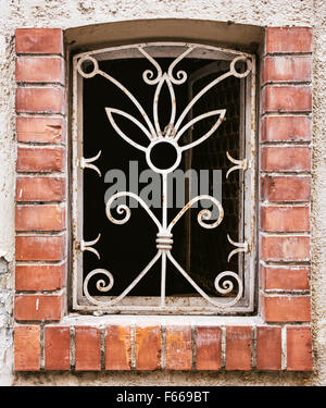 Old barred window on the wall. Architectural elements. Stock Photo