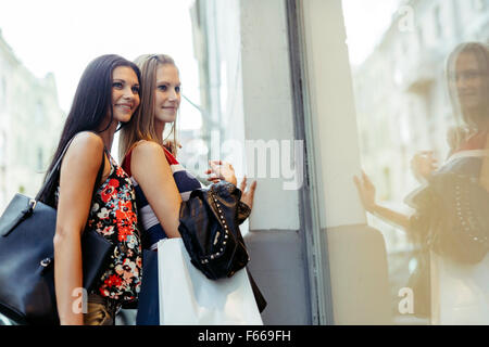 Beautiful women shopping spree on street Stock Photo