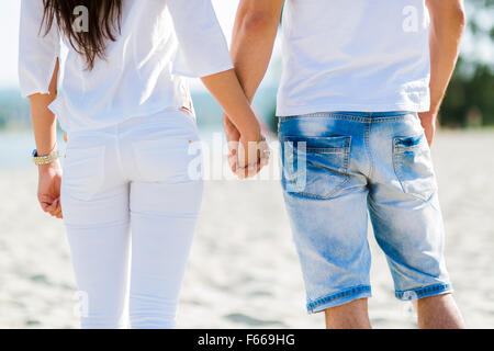 Romantic couple holding hands on a beach