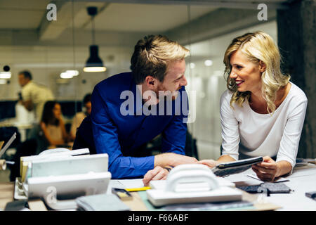 Two designers talking about possible trends ideas and new fashion styles. Teamwork Stock Photo