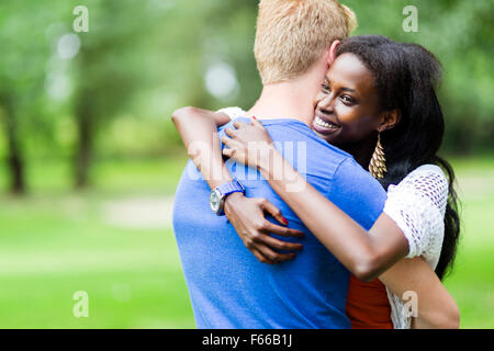 Couple in love hugging peacfully outdoors and being truly happy. Feeling of security and serenity Stock Photo