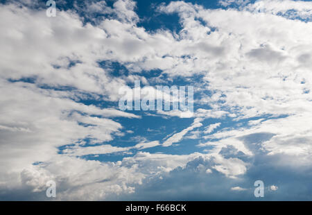 Growing Cumulus clouds formation, blue sunny sky and white escalating clouds view, puffy cloudscape in good weather, horizontal Stock Photo