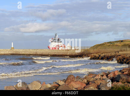 An oil rig supply vessel enters the North Sea from Aberdeen Harbour Stock Photo