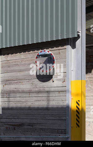 A convex safety mirror on a storage bay improving visibility on a quarry site Stock Photo