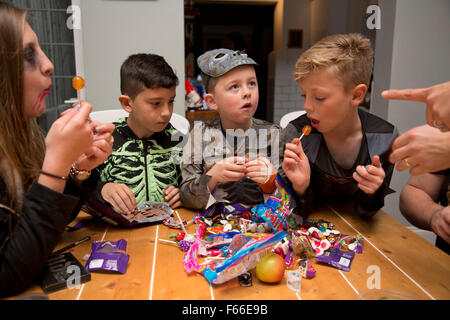 Children sharing out sweets on Halloween Stock Photo