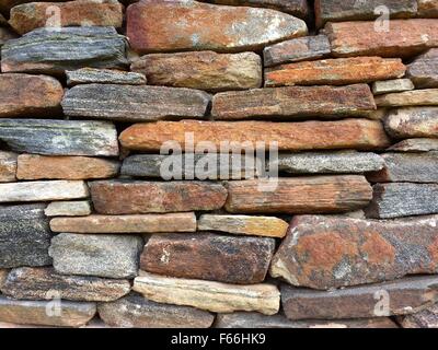Stone wall pattern from old log cabin chimney Stock Photo