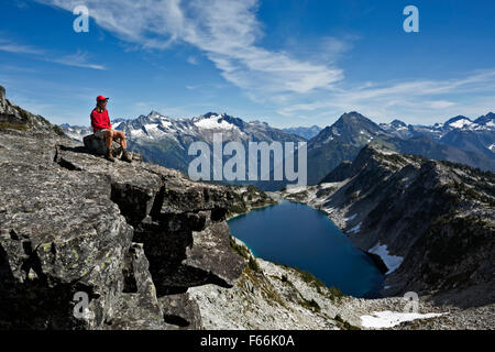 WASHINGTON - Hiker over looking Hidden Lake and the North Cascades from Hidden Lake Peaks in the North Cascades National Park. Stock Photo