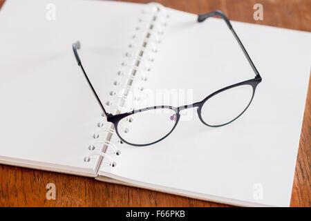 Eyeglasses on opened spiral notebook , stock photo Stock Photo