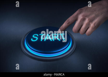 Close up shot of finger pressing the start button Stock Photo