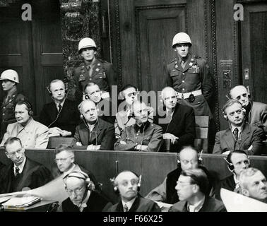 Nuremberg Trials defendants photographed in the dock, in two rows. Front row, left to right: Hermann Goering, Joachim von Ribbentrop, Wilhelm Keitel, and Alfred Rosenberg. Back row, left to right: Karl Doenitz, Erich Raeder, Baldur von Schirach, Fritz Sauckel, and Alfred Jodl. Stock Photo