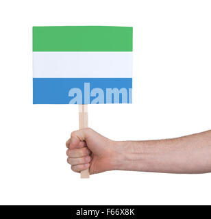 Hand holding small card, isolated on white - Flag of Sierra Leone Stock Photo